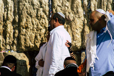 Rear view of people standing on cross