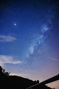 Low angle view of silhouette trees against sky at night