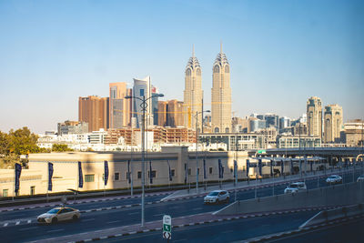 View of buildings in city against clear sky