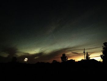 Low angle view of silhouette trees against sky at dusk