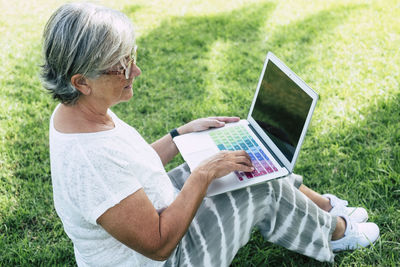 High angle view of senior woman using laptop