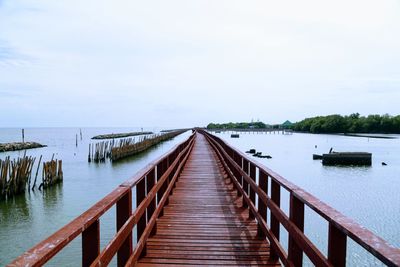 Pier over sea against sky