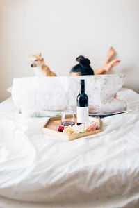 Close-up of red wine in wineglass on bed at home