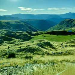 Scenic view of landscape and mountains against sky