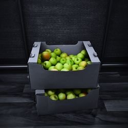 High angle view of apples in container on table