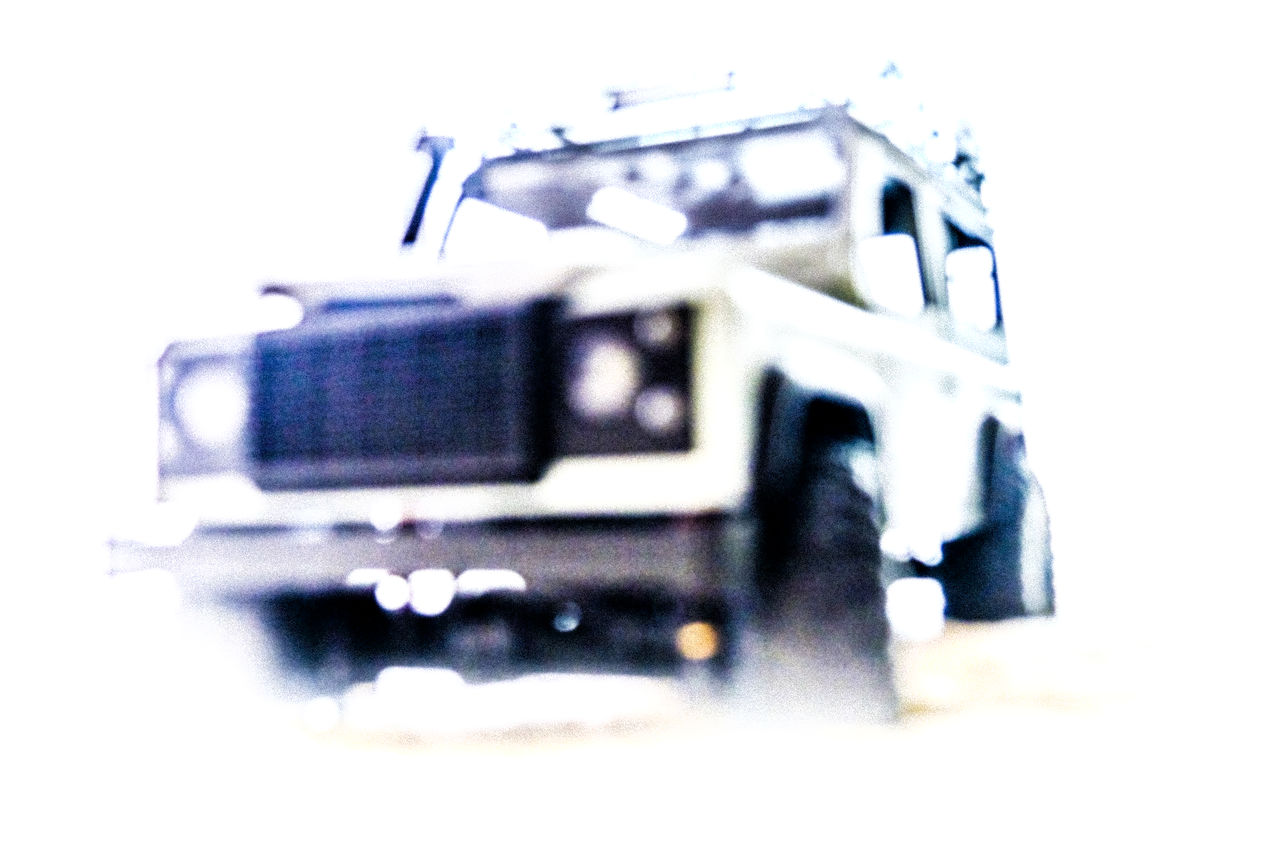 vehicle, toy, technology, white background, transportation, model car, no people, motor vehicle, car, truck, mode of transportation, indoors, close-up, studio shot, selective focus