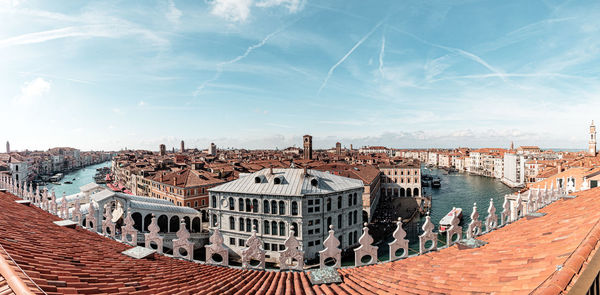 Panoramic view of buildings in city against sky