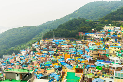 High angle view of townscape and mountains against sky