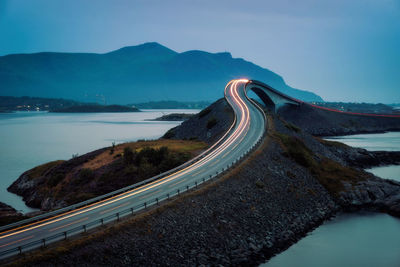 Road by mountain against sky