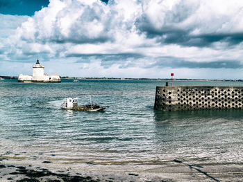 Harbor on sea at bourcefranc-le-chapus against cloudy sky