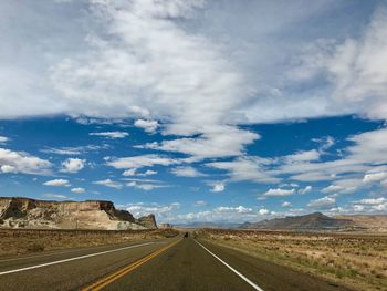 Empty road along countryside landscape