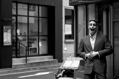 Young man looking through window