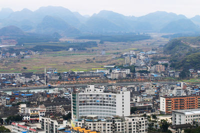 High angle view of townscape against mountains