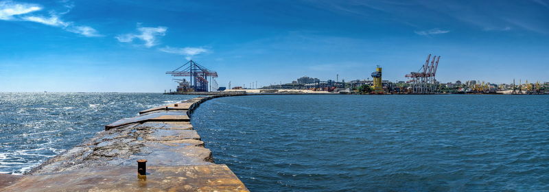 Lighthouse at the entrance to the harbor of odessa seaport, on a sunny summer day