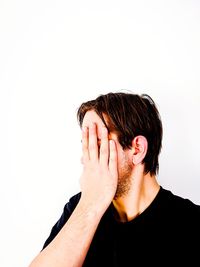 Close-up of man covering face