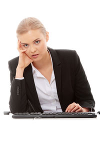 Mid adult woman using mobile phone against white background