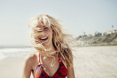 Portrait of cheerful woman on beach