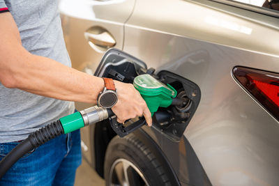 Midsection of man washing car