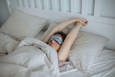 Young woman sleeping on bed at home