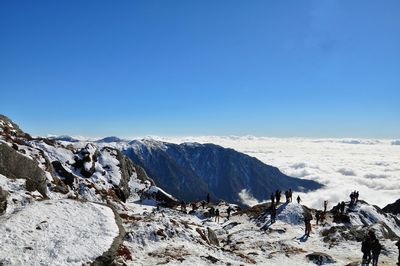 Scenic view of snowcapped mountains against clear blue sky