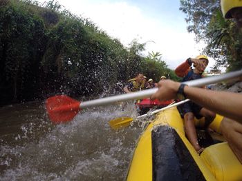 Man surfing on boat in river