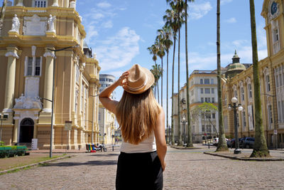 Rear view of young traveler woman in the historic center of porto alegre, rio grande do sul, brazil.