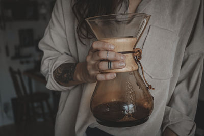 Woman holding carafe with coffee