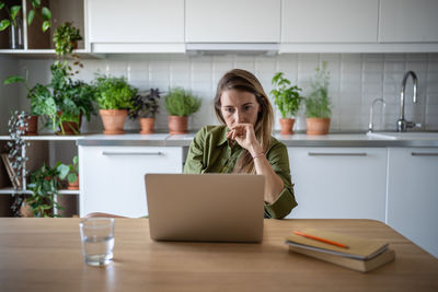 Businesswoman using laptop at desk