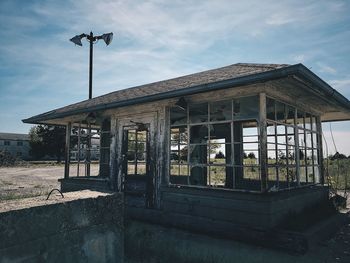 Abandoned building on field against sky