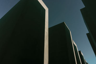 Low angle view of skyscraper against sky at night