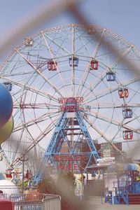 Low angle view of ferris wheel against sky