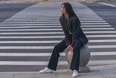 Portrait of young woman walking on steps