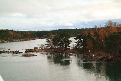 Scenic view of lake against cloudy sky