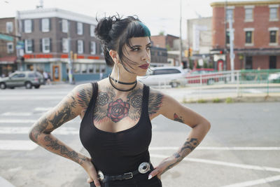 A portrait of a young woman with black and blue hair.