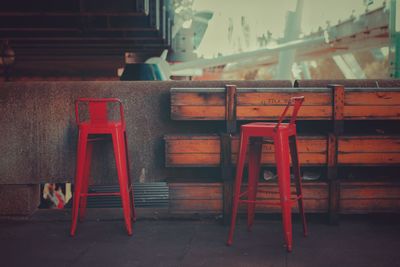 Red stools by retaining wall