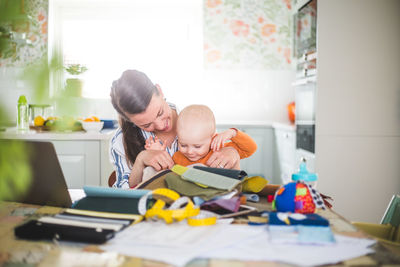 Mother and son on table at home