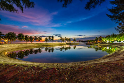 Scenic view of lake against sky at sunset