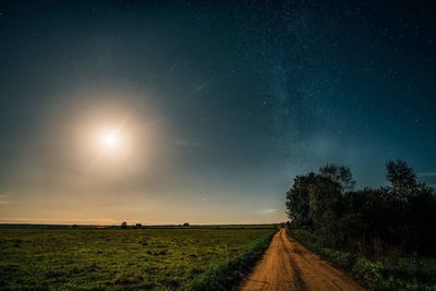 Scenic view of field against sky at night