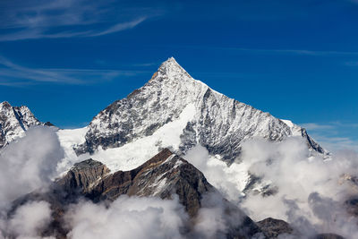 Scenic view of snow covered mountains against sky