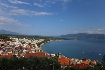 High angle view of townscape by sea against sky