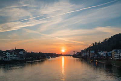 View of river in town at sunset