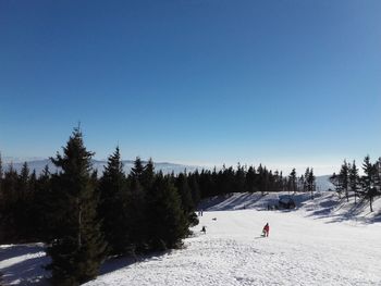 Snowcapped landscape against clear sky