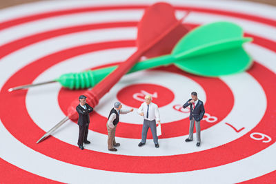 Close-up of figurines on dartboard