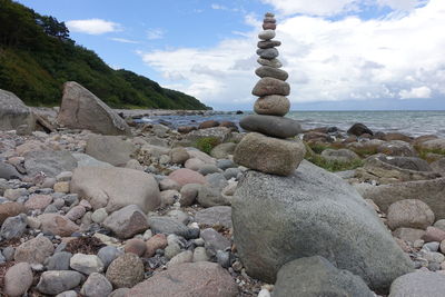 Rocks by sea against sky