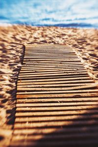 Close-up of sand at beach against sky