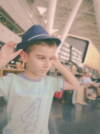 Close-up of boy wearing hat at airport