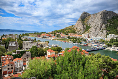 Panoramic shot of townscape by sea against sky