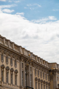 Low angle view of historical building against cloudy sky