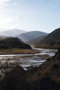 Scenic view of lake and mountains against sky