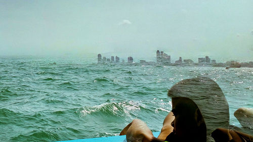 View of sea with cityscape in background